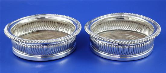 A pair of late George III silver coasters, approx. 6in.